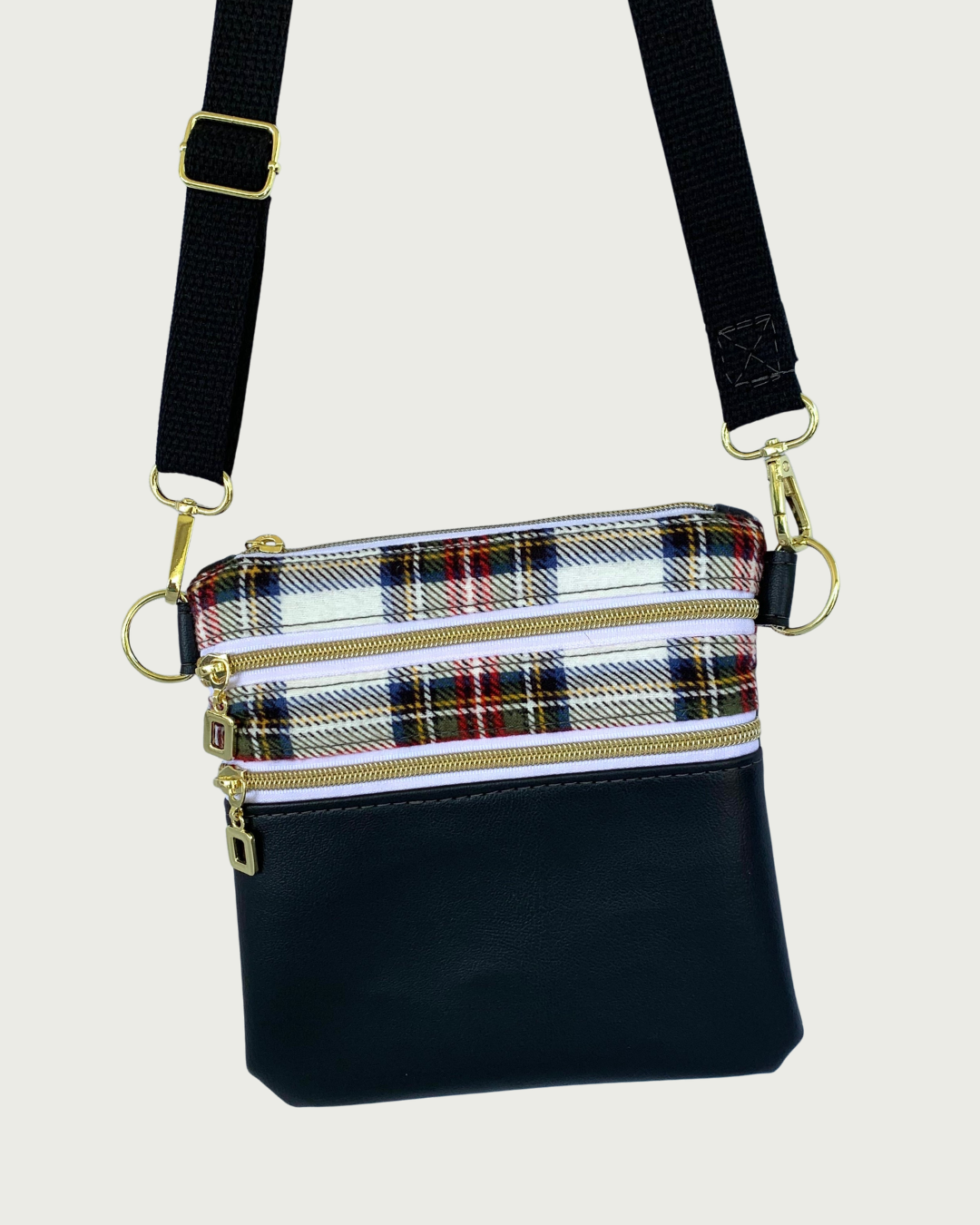 Handcrafted classic red, black, and white plaid crossbody bag with black faux-leather accents, gold-tone hardware throughout including zipper details on top closure and two pockets, and a black adjustable, detachable cotton webbing shoulder strap, shown on a light gray background.