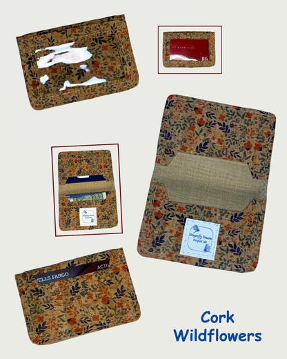 Handcrafted compact bifold wallet made from cork leather printed with sweet wildflowers. Five views are shown. Two views are of the wallet open, one displays cash and cards in both slots while the other shows the slots devoid of cash and cards. A Dragonfly Dreams label is sewn onto the bottom card pocket and is shown in both these views. The front of the wallet is shown in two views showing a clear vinyl window with and without cards. The fifth view is of the back of the wallet showing a card in the slot. T