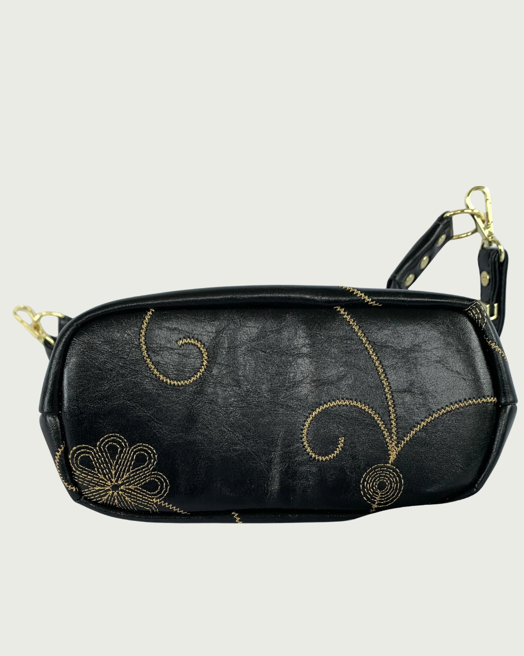 Handcrafted black vinyl slouchy shoulder bag bottom view showing the decorative gold stitching.