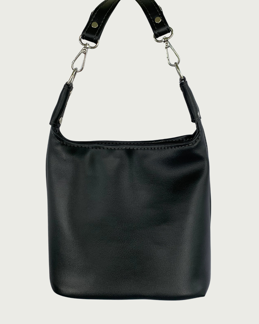 Handcrafted black vinyl slouchy shoulder bag with detachable strap.