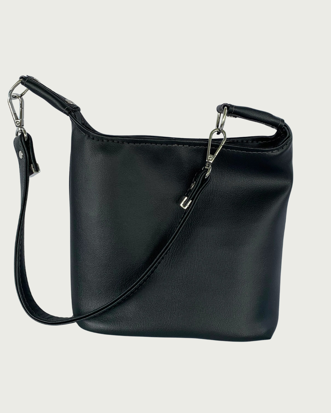 Handcrafted black vinyl slouchy shoulder bag with detachable strap.