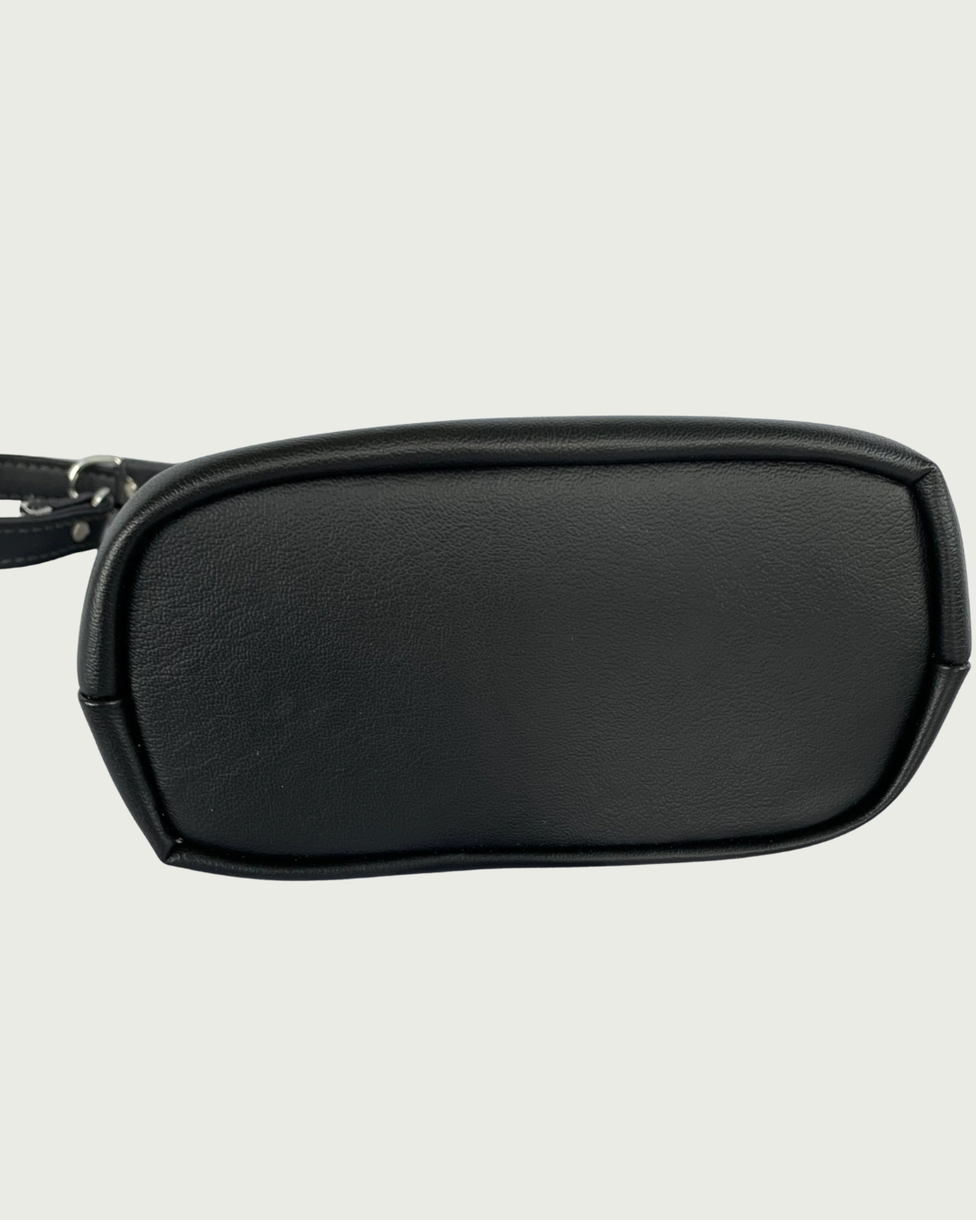 Handcrafted black vinyl slouchy shoulder bag with view of the bag bottom.