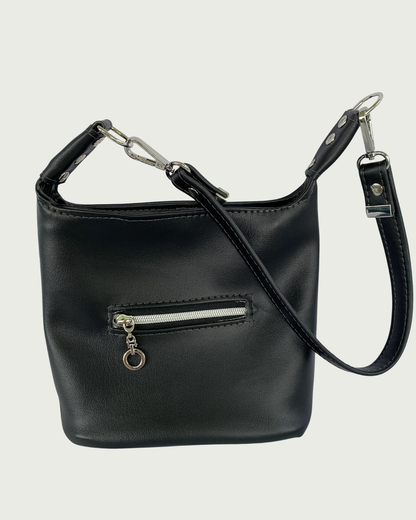 Handcrafted black vinyl slouchy shoulder bag with small exterior zippered pocket, nickel hardware, and detachable strap.