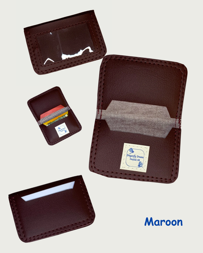 Handcrafted compact bifold wallet made from vegan maroon marine vinyl. Four views are shown. One view is the wallet open displaying cash and cards in both slots while another shows the same view but devoid of cash and cards. A Dragonfly Dreams label is sewin onto the bottom card pocket and is shown in both these views. A third view is of the front showing a clear vinyl window with no cards. And the fourth view is of the back of the wallet showing a card in the slot. The word Maroon is displayed in the botto