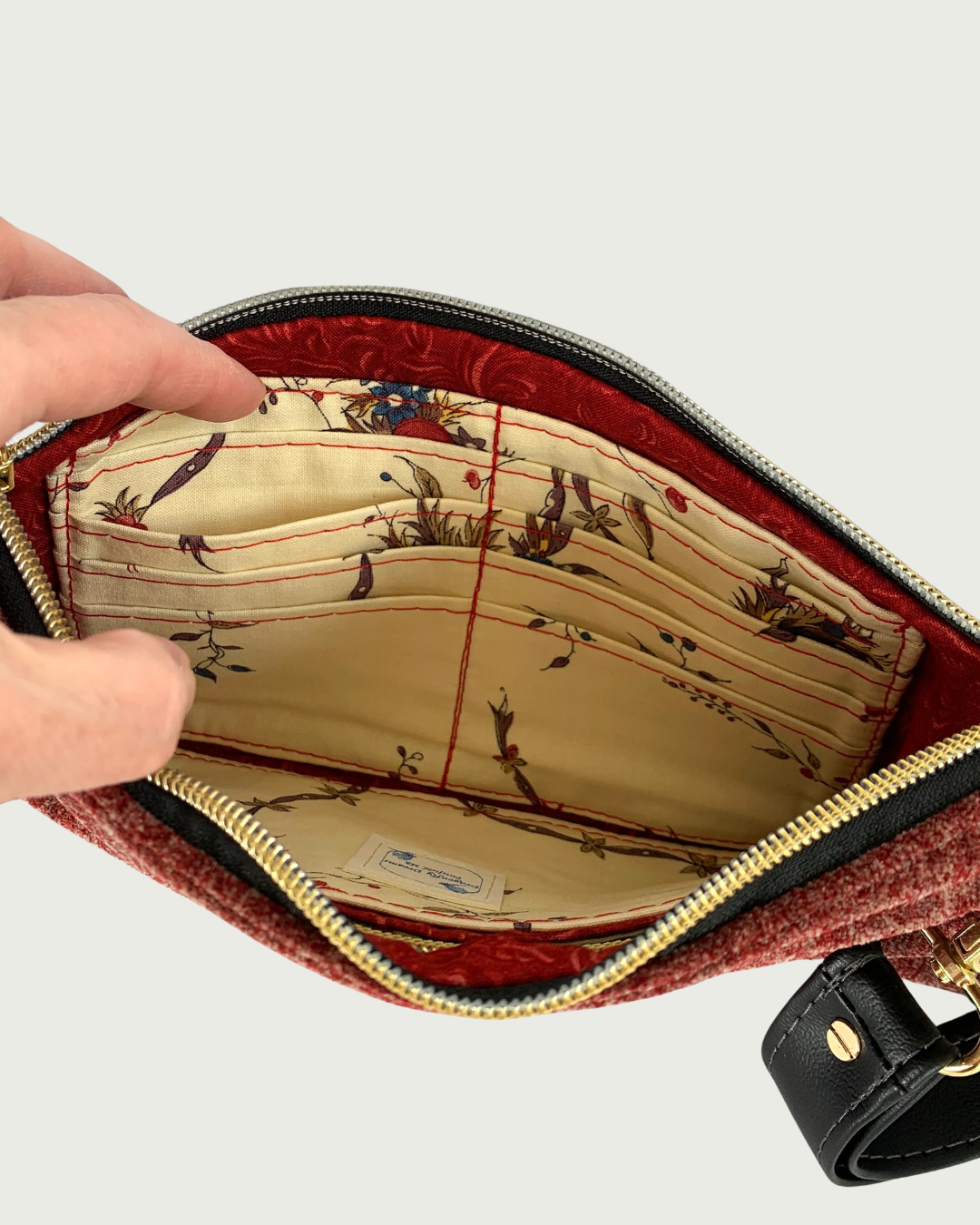 Handmade merlot chenille-like polyester wristlet wallet with a black faux leather detachable wrist strap. Eight card slots are built into the interior that is held open by a couple of fingers.