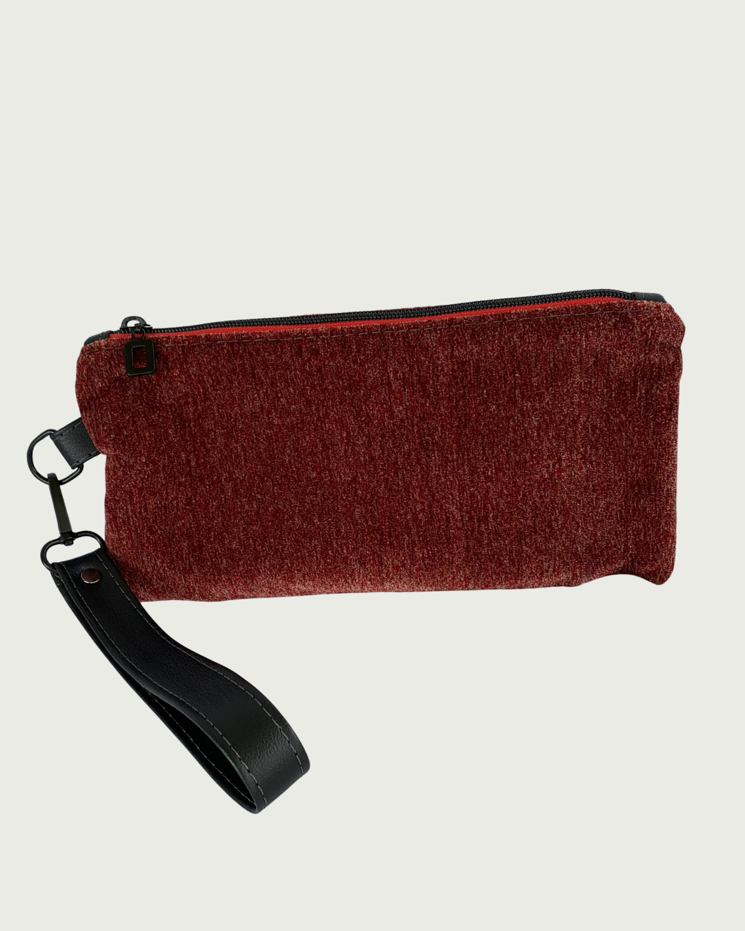 Handcrafted merlot chenille-like polyester wristlet wallet featuring a detachable, black faux leather wrist strap and matt black hardware including an open square top zipper of burgundy zipper tape.
