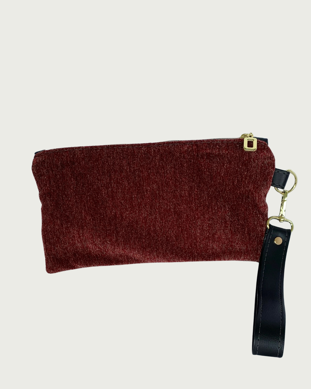 Handcrafted merlot chenille-like polyester wristlet wallet featuring a detachable, black faux leather wrist strap and gold-tone hardware including an open square top zipper.
