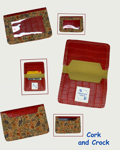 Handcrafted compact bifold wallet made from red faux crocodile leather with floral cork leather overlays on front and back making up the card slots. Six views are shown. Two views are of the wallet open displaying cash and cards in both slots of one while the other shows the wallet empty. A Dragonfly Dreams label is sewn onto the bottom card slot. Two views are of the front showing a clear vinyl window, one view with cards and one with no cards. The final two views are of the back of the wallet, one showing