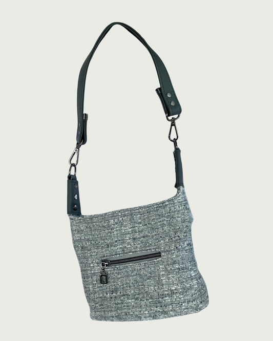 A gray wool-like shoulder bag with detachable gray vinyl strap, gunmetal hardware, and small zippered pocket.