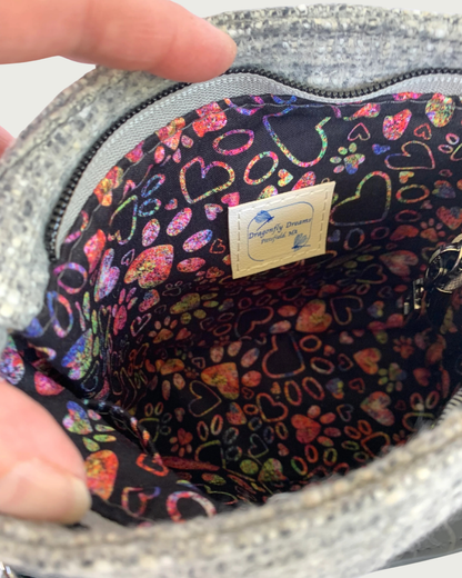 Gray wool-like handbag's multicolored interior lining of pawprints and hearts and a Dragonfly Dreams tag sewn in.