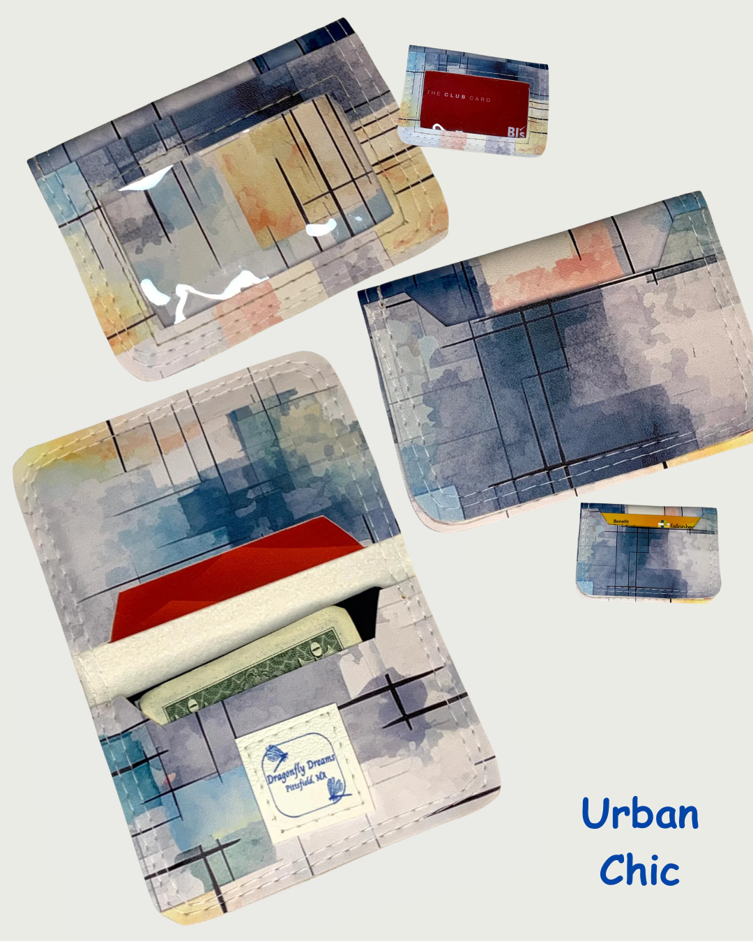 Handcrafted compact bifold wallet made from faux leather with a watercolor print of blues, corals, yellows with bold black hashmark lines, giving it an urban chic look. Five views are shown. One view is the wallet open displaying cash and cards in both slots. A Dragonfly Dreams label is sewn onto the bottom card pocket. Two views are of the front showing a clear vinyl window, one with cards and one without cards. Two views are of the back of the wallet, one showing a card in the slot, the other has no cards