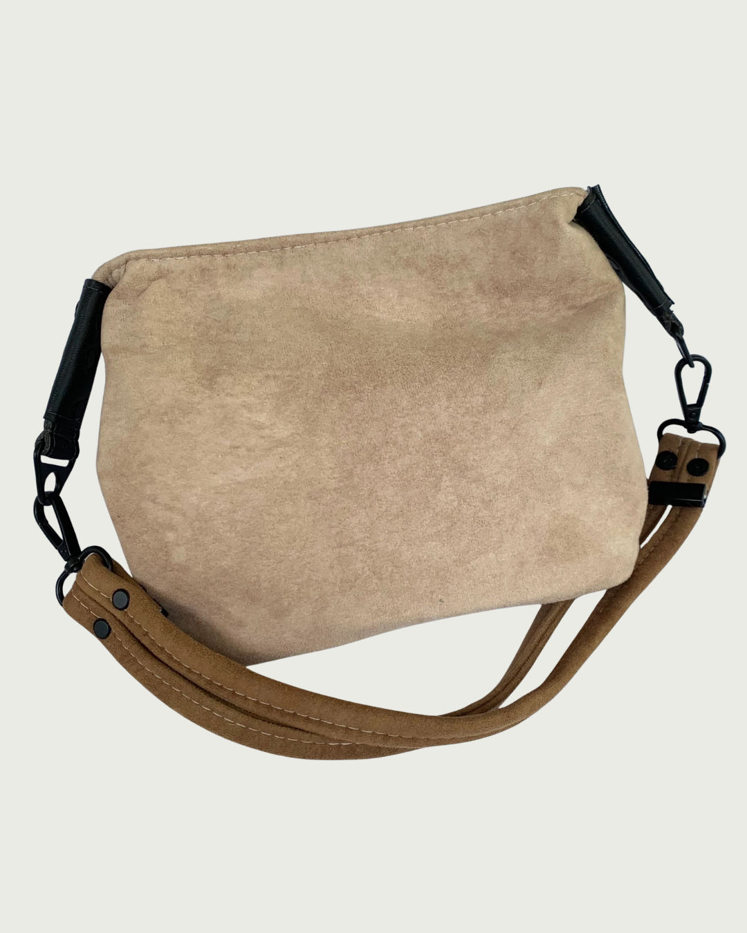 A 2-toned  brown faux suede shoulder bag with black faux-leather strap connectors and brown dual strap.