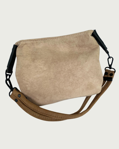 A 2-toned  brown faux suede shoulder bag with black faux-leather strap connectors and brown dual strap.
