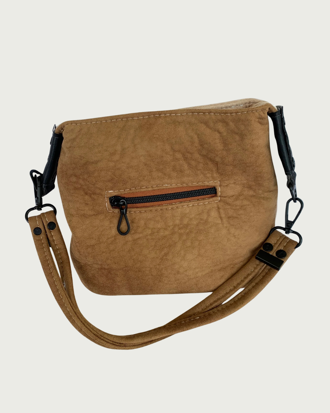 A brown faux-suede shoulder bag with a small zippered pocket and a removable shoulder strap.