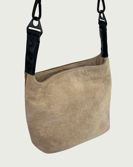 A 2-toned faux suede shoulder bag with black faux-leather strap connectors as seen from front or back-wearer's choice.
