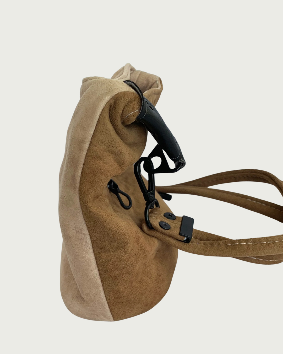 A 2-toned  brown faux suede shoulder bag shown slouchy from the side.