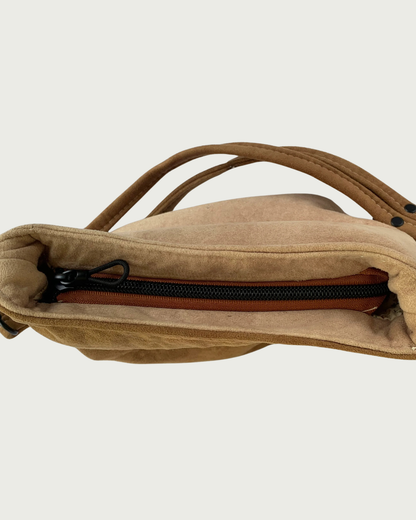 A 2-toned brown faux suede shoulder bag  with a closeup view of the top recessed zipper.