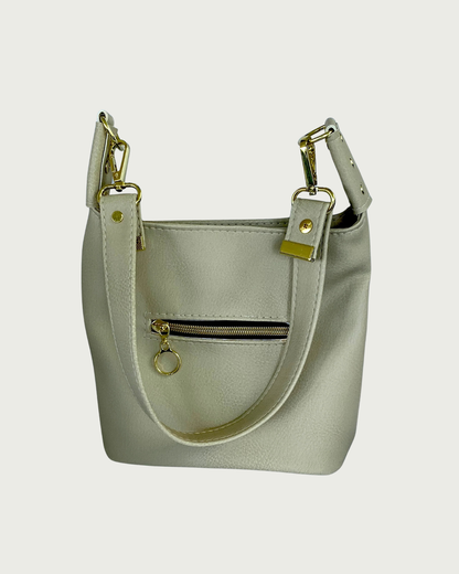 A solid beige faux leather slouchy  shoulder bag with small exterior zippered pocket as seen from front or back-wearer's choice.